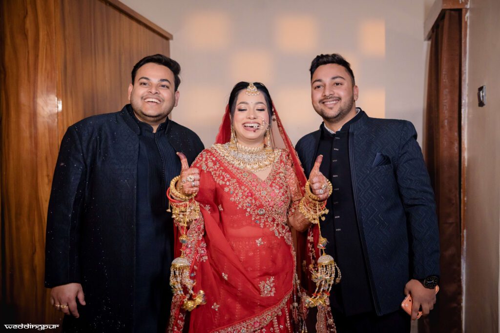 Bride smiling with friends showing thumbs up during wedding