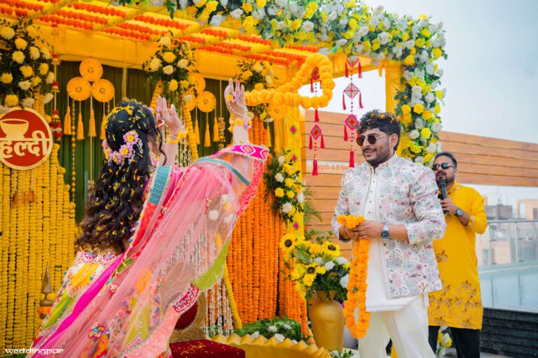 Bride and groom during haldi garland moment captured by candid wedding photographer in Patna